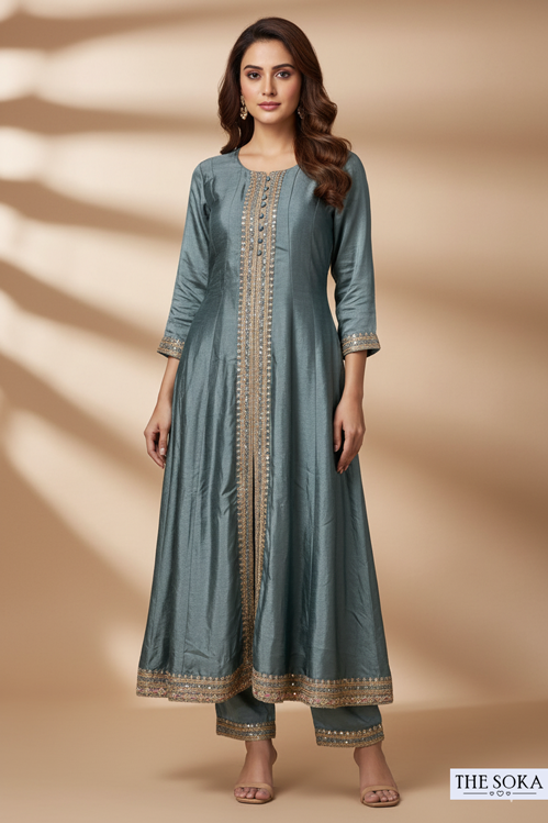 Woman wearing a long blue dress with gold embroidery on a beige background