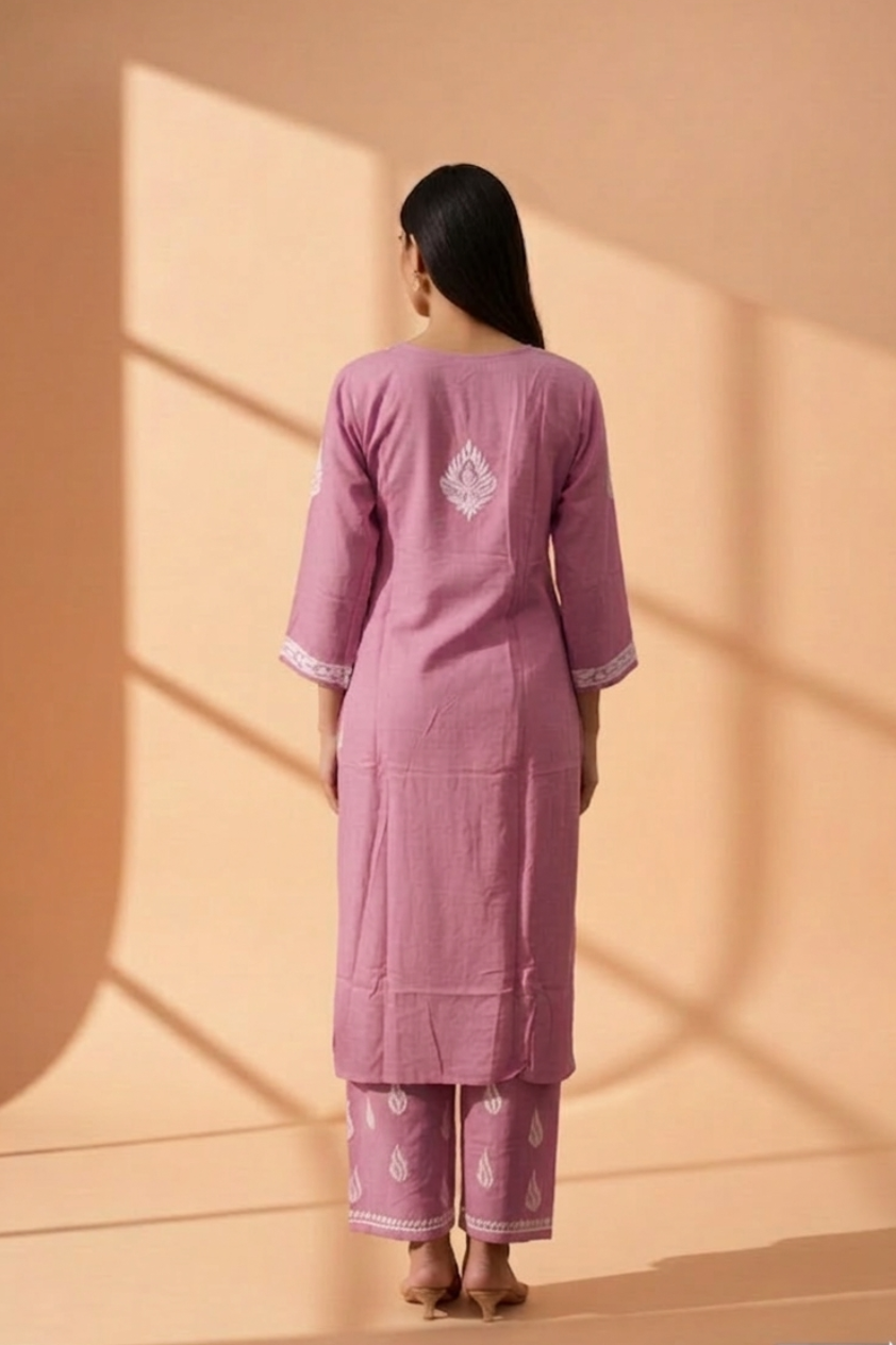 Woman wearing a pink muava chikankari set