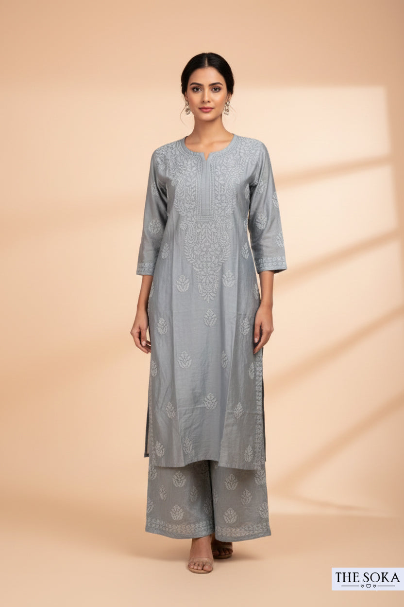 Woman wearing a gray kurta with matching pants against a beige background
