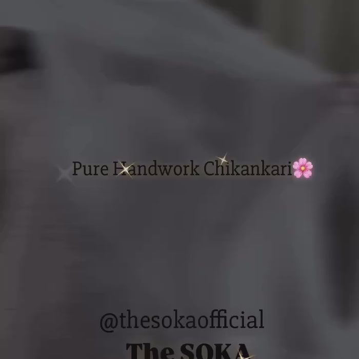 Woman wearing a white chikankari kurti set 